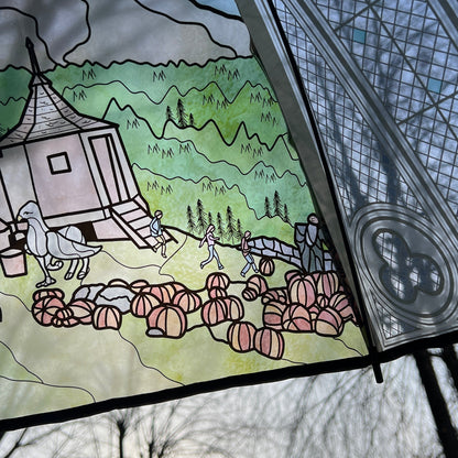 Wizard-inspired stained glass canopy umbrella featuring illustrated panels of a magical castle, whimsical crooked house, enchanted willow tree, grand candlelit dining hall, and vintage steam train.