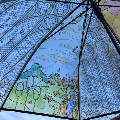 Decorative umbrella with stained glass design featuring a castle and landscape.